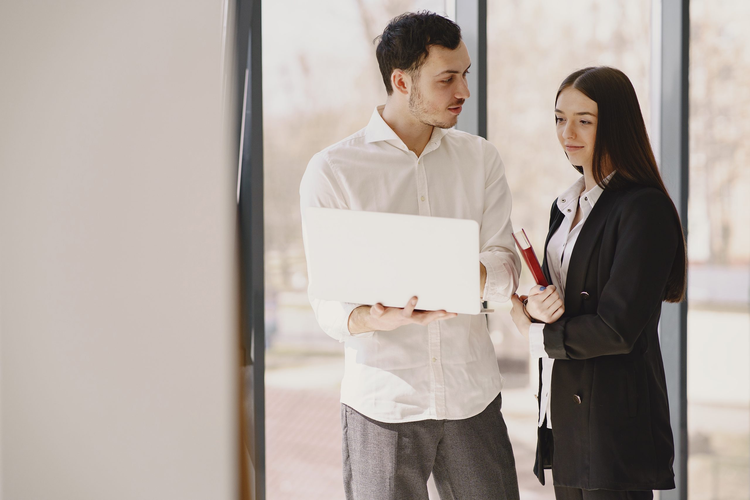 Team members using Zoho CRM software in a modern workspace to manage customer interactions, provide customer support, track sales performance, automate tasks, and collaborate on business insights through real-time data analytics.